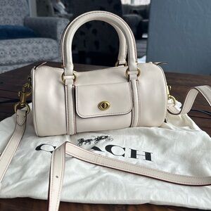 Coach white leather trimmed top handle barrel handbag.
